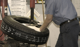 Repairman detaching the tire